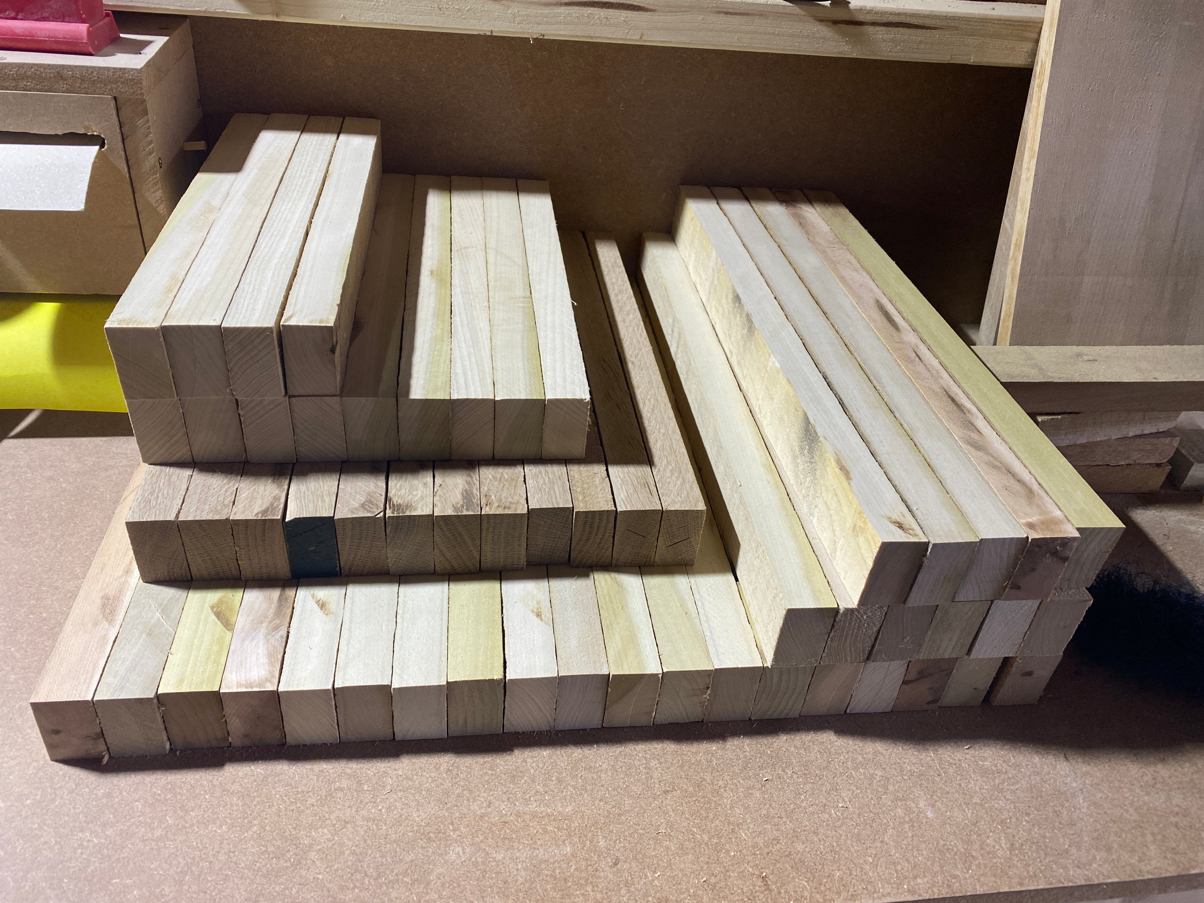 Wooden blocks arranged in a geometric pattern on a flat surface