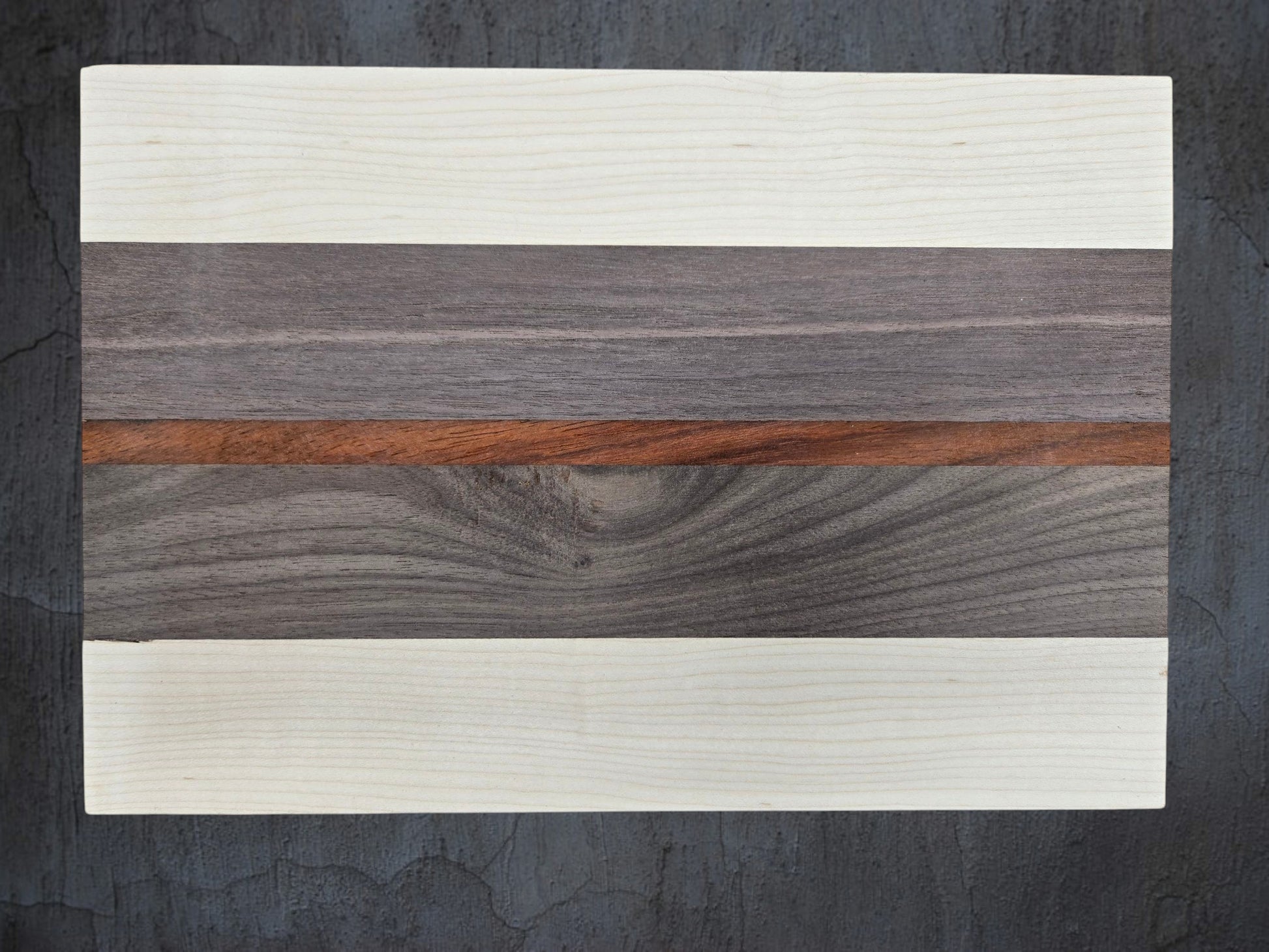 Close up of ash walnut and pink ivory wood grain on cheese board
