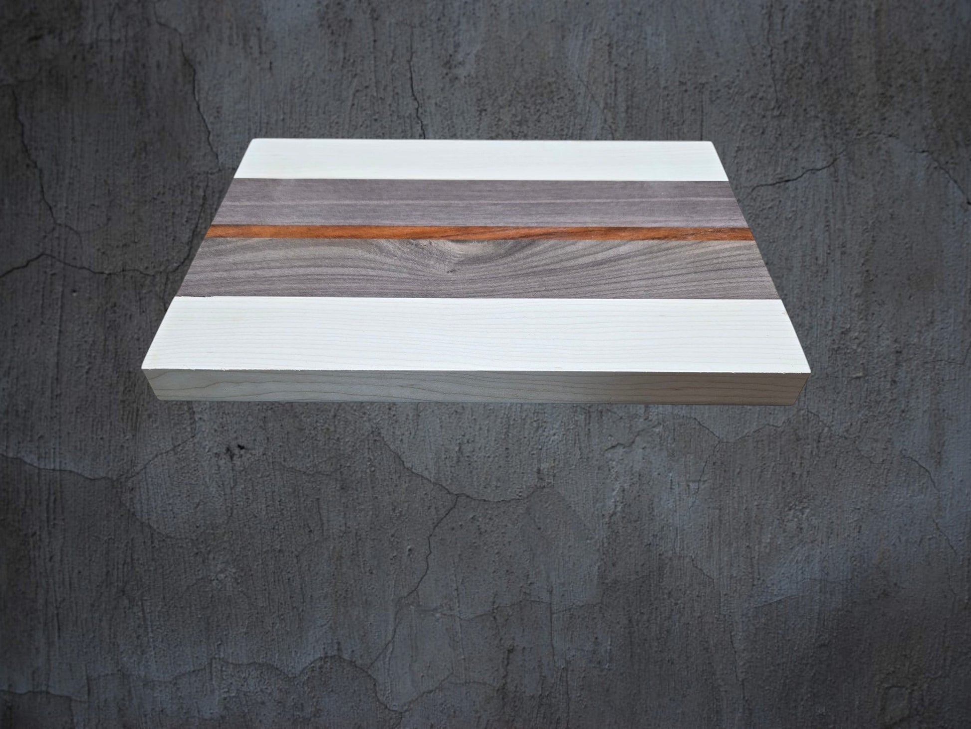 Ash walnut and pink ivory cheese board used for serving cheese and charcuterie