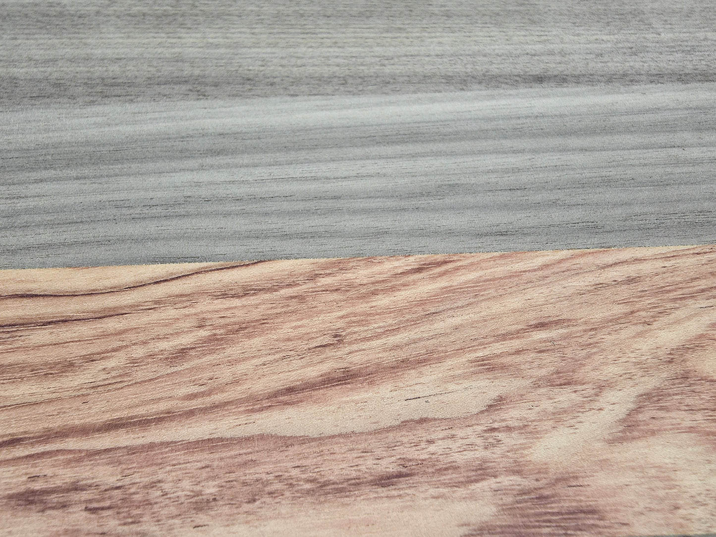 Close up of walnut and pink ivory wood grain on luxury cheese board