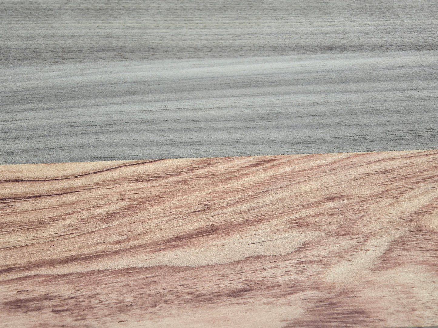 Close up of walnut and pink ivory wood grain on luxury cheese board