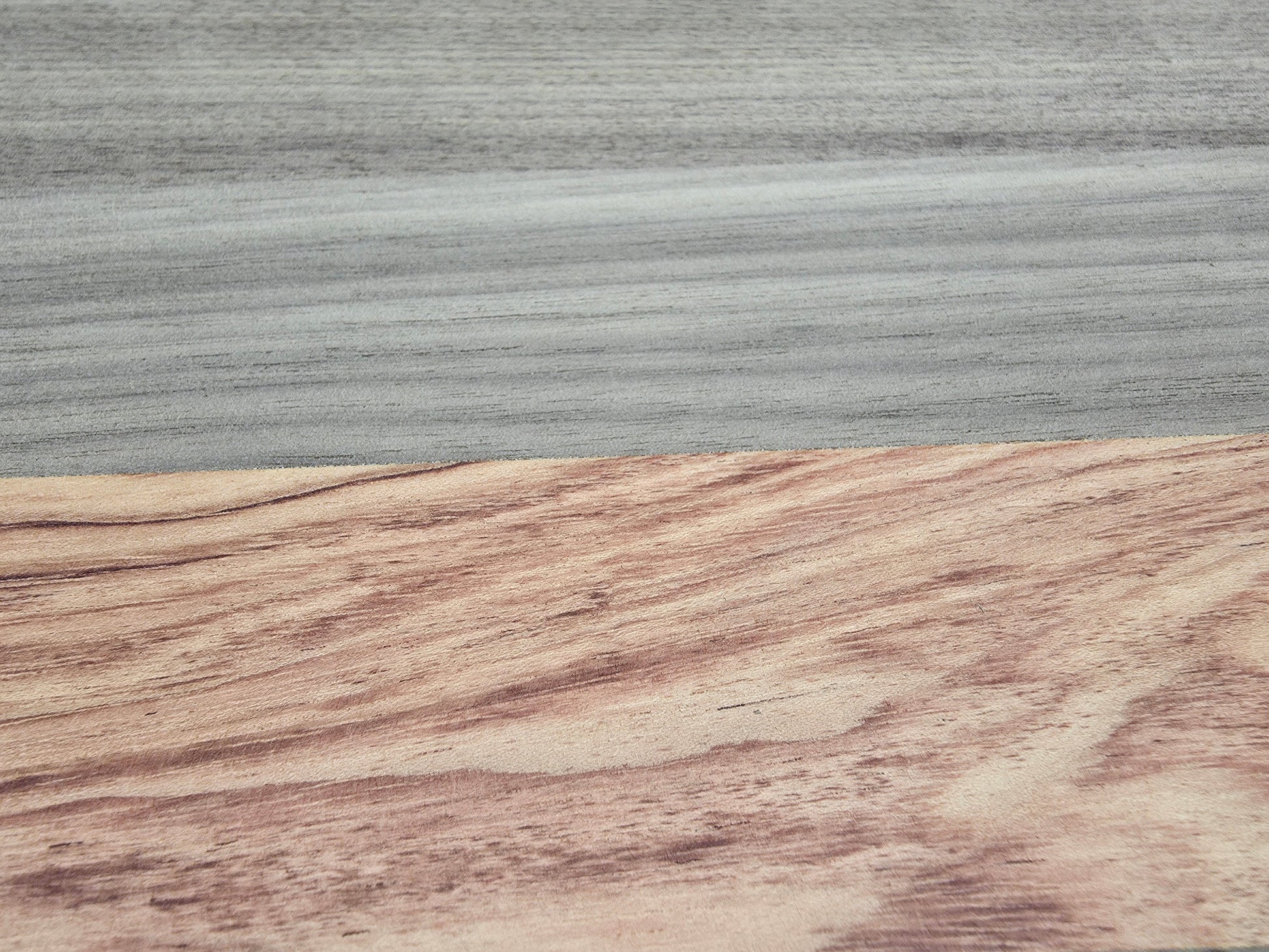 Close up of walnut and pink ivory wood grain on luxury cheese board