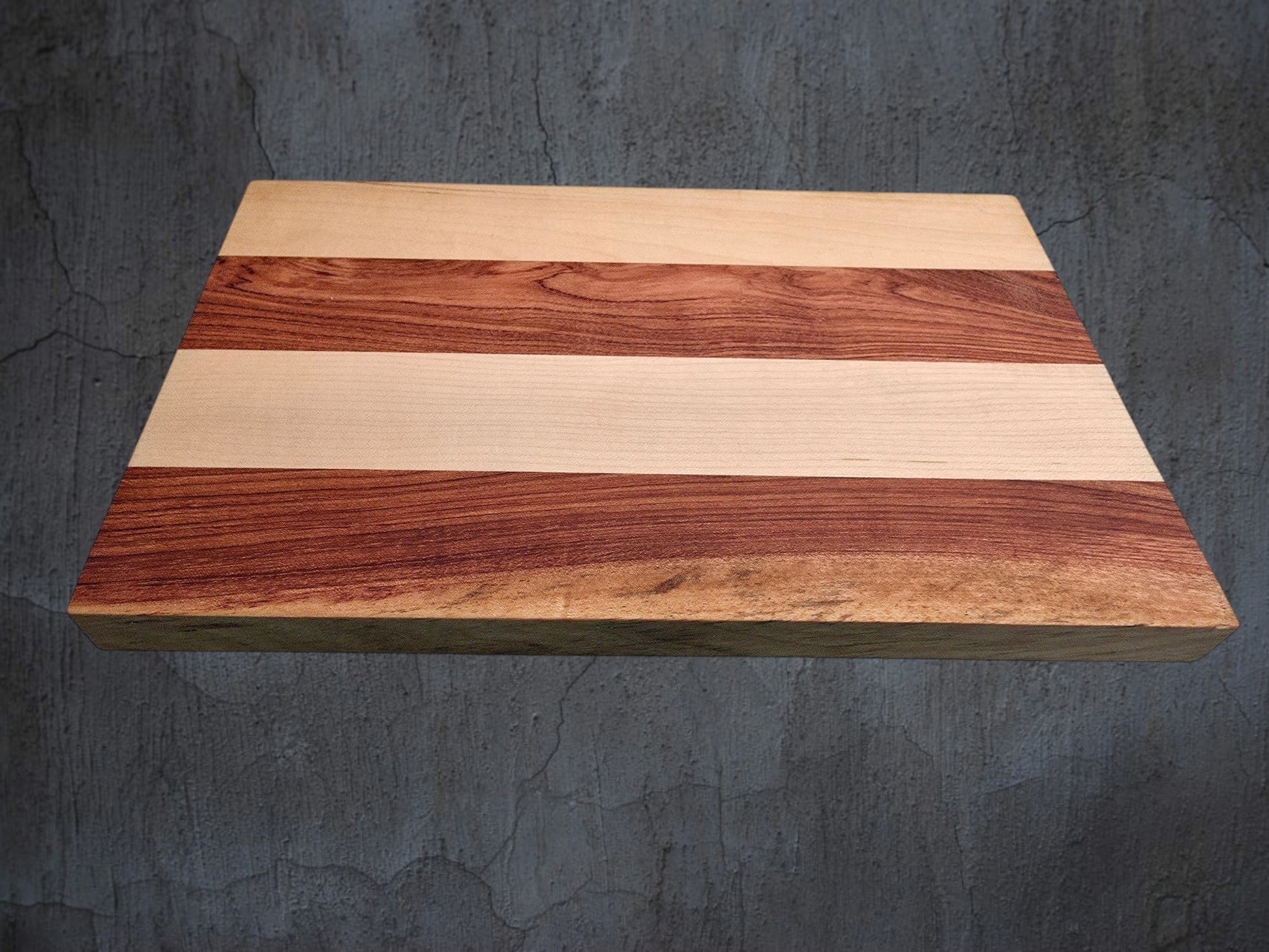 Pink ivory and ash cheese board used for serving cheese and charcuterie