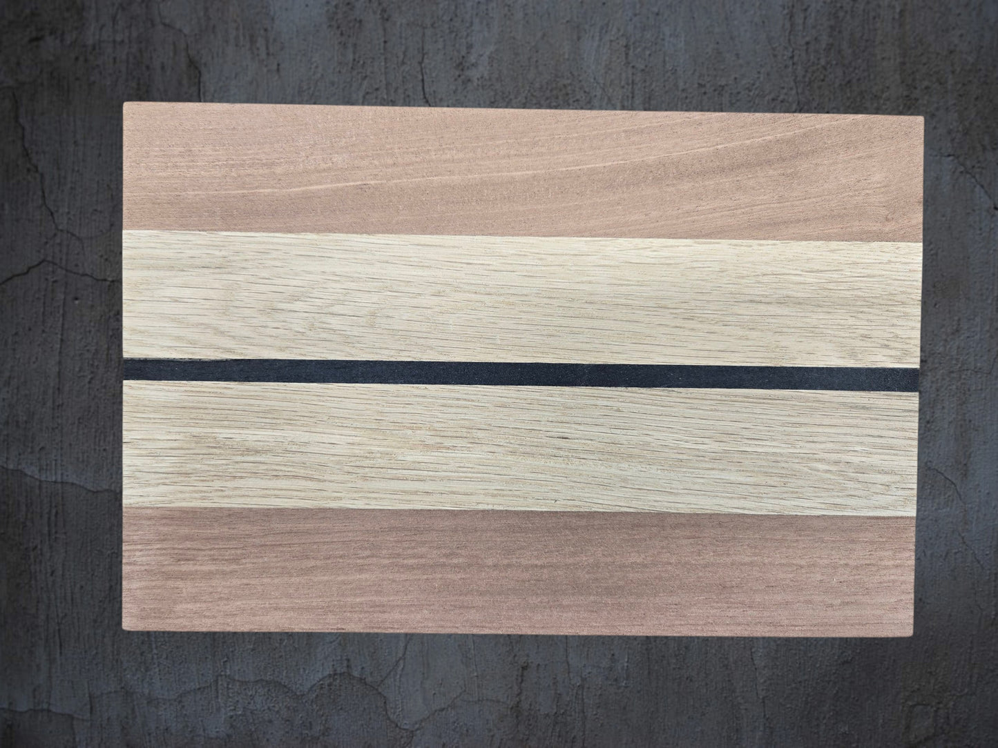 Close up of walnut oak and ebony wood grain on cheese board