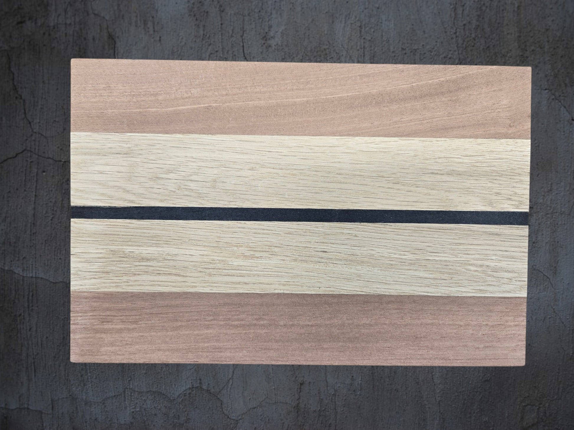 Close up of walnut oak and ebony wood grain on cheese board